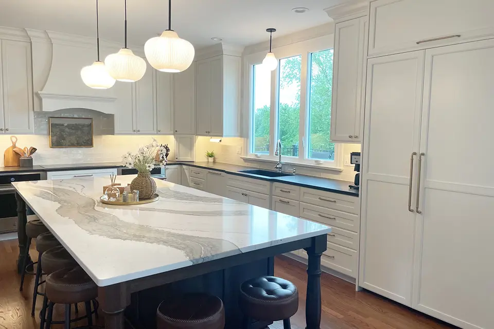 Modern kitchen with marble countertop and island.
