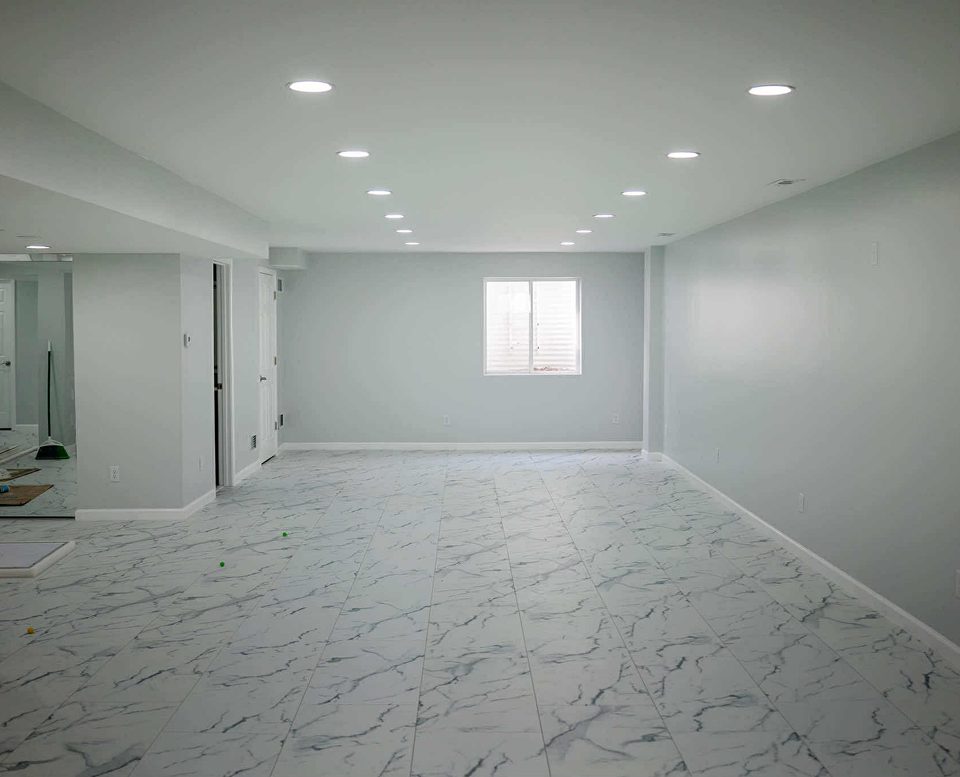 Spacious room with marble floor tiles.