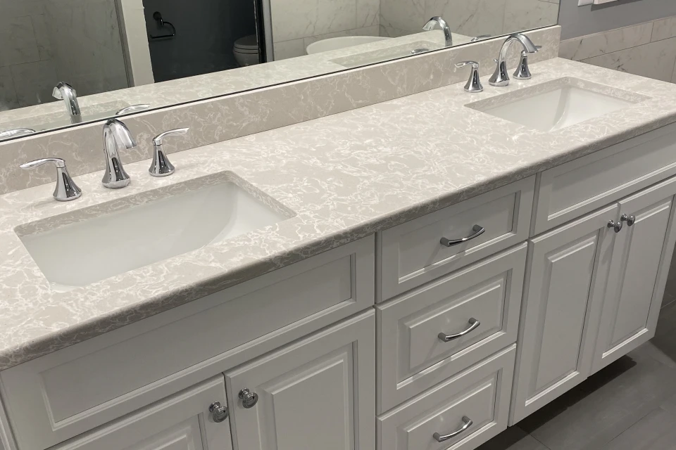 White double sink vanity with marble countertop.