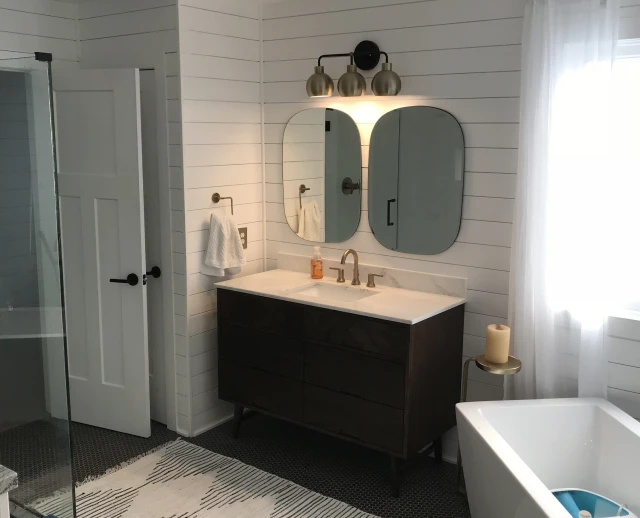 Modern bathroom with vanity and bathtub.