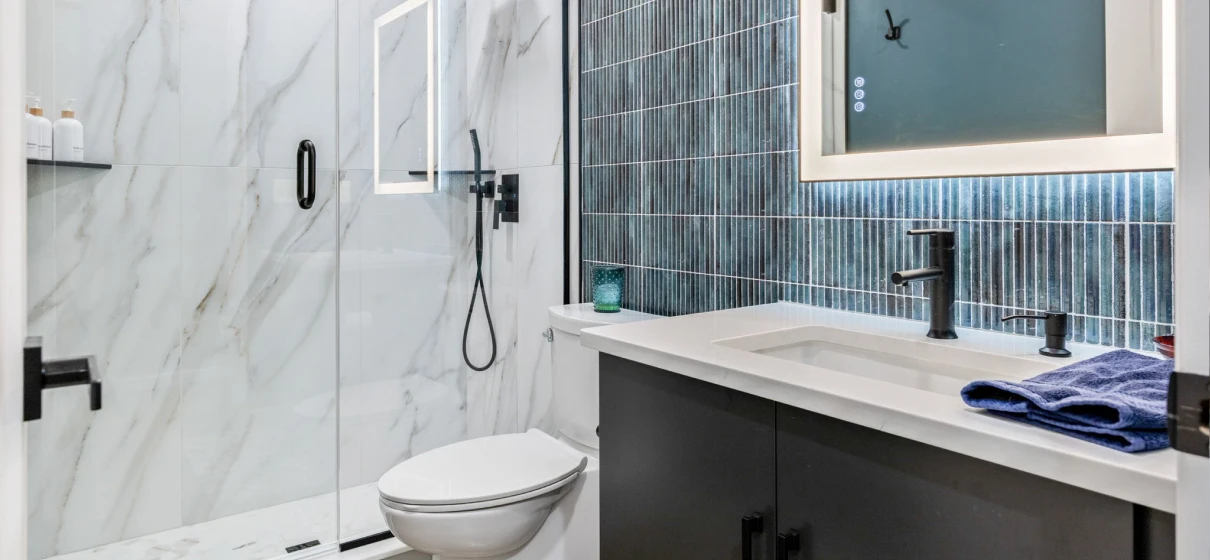 Modern bathroom with glass shower and vanity.